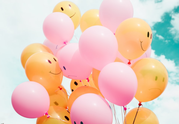 Balloons with happy and sad faces drawn on