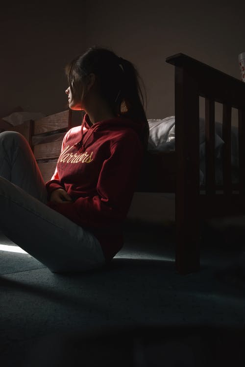 A girl sitting in a dark room