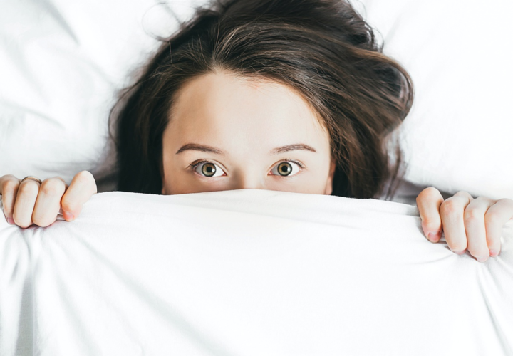 a woman lying awake in bed