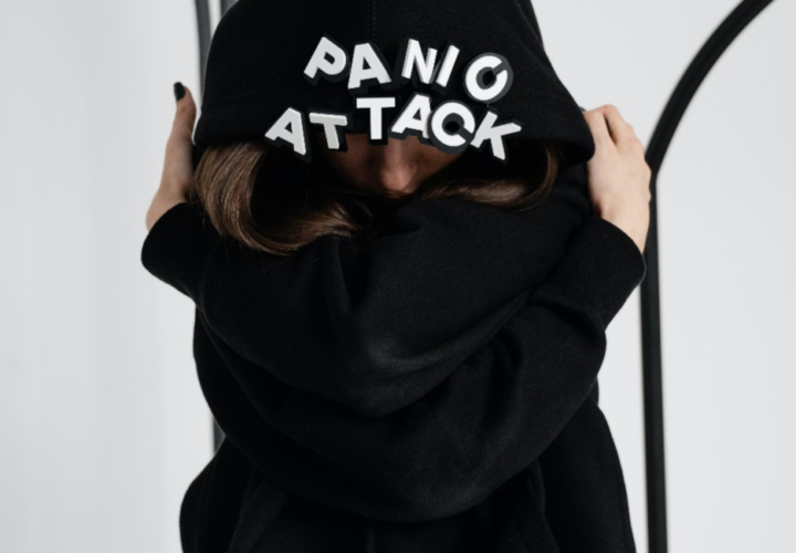 A person wearing a hoodie that says panic attack