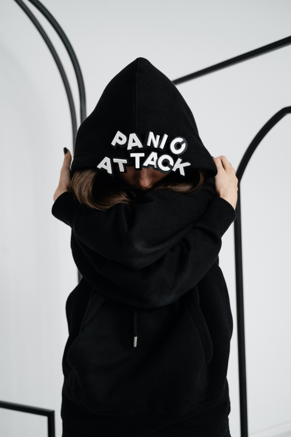 A person wearing a hoodie that says panic attack