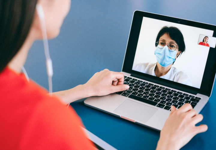 An image of a woman taking a doctor’s consultation on a video call