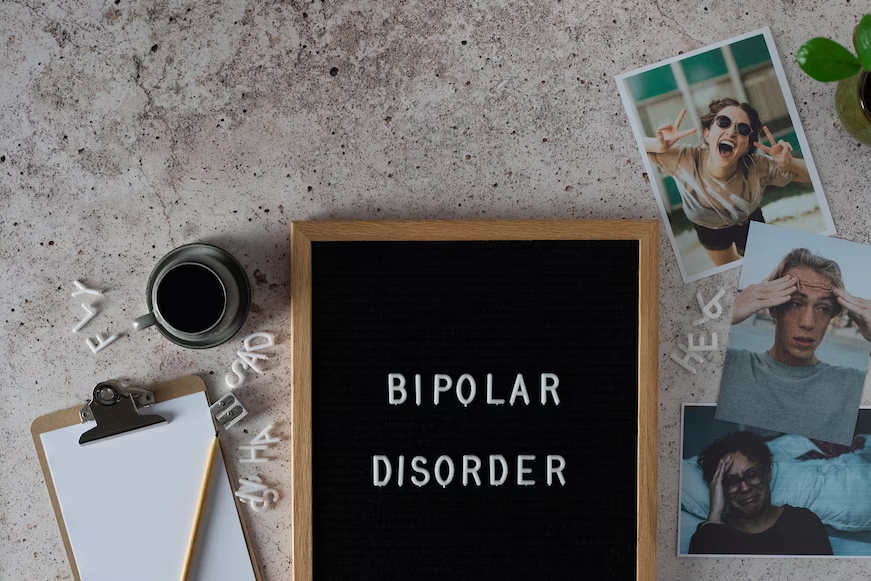 Bipolar disorder written on a board next to pictures 